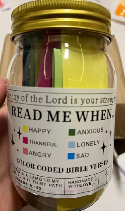 Jar with colorful labels and a gold lid, featuring text and color codes.