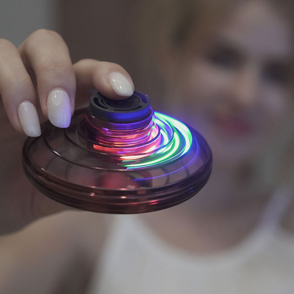 Hand holding a colorful fidget spinner with a blurred background
